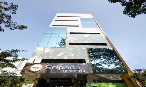a building with a sign in front of it at Treebo Trend Sripadha Residency Alipiri Road in Tirupati