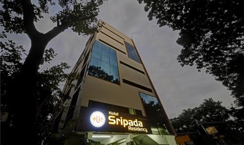 a building with a sign on the side of it at Treebo Sripadha Residency Alipiri Road in Tirupati