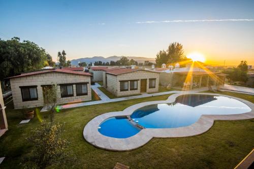 a backyard with a swimming pool and a house at Real de Corralejo in San Miguel de Allende