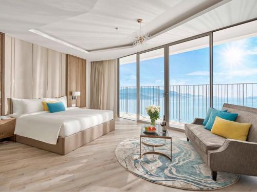 a hotel room with a bed and a couch at Handy Panorama Nha Trang Ocean view by HDG in Nha Trang