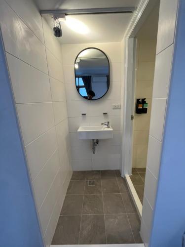 a bathroom with a sink and a mirror at Rolling Pin Homestay in Tainan