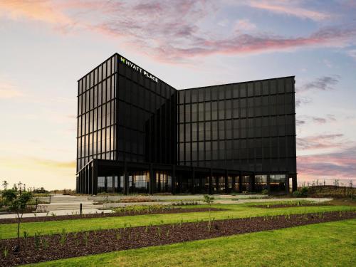 a black building with a lot of windows at Hyatt Place Melbourne Caribbean Park in Scoresby