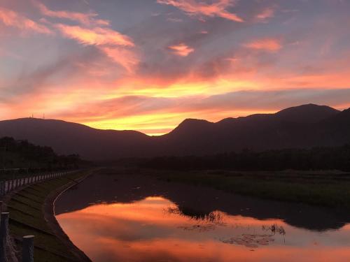 a sunset over a body of water with mountains at Thanh Binh Hotel Con Dao in Con Dao