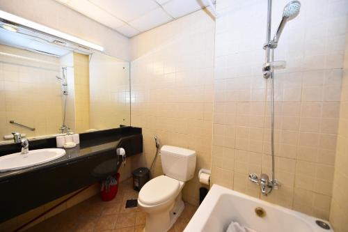a bathroom with a toilet and a sink and a shower at Luxury Escapes - Budget Studio with Garden Views near Metro - MED64 DG in Dubai
