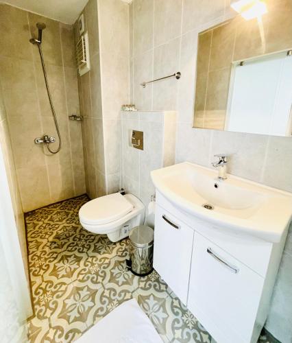 a bathroom with a toilet and a sink at QONAQ HOTEL & SUITES in Istanbul