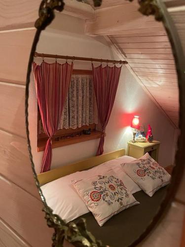a bedroom with a bed and a mirror at Dom pod kogutem in Laliki