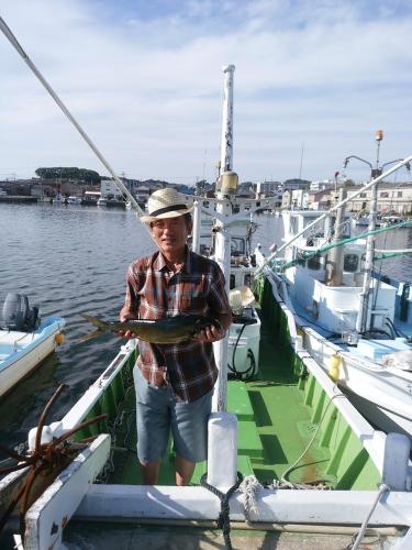 a man standing on a boat holding a fish at Mirai Noen in Tanabe