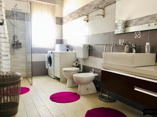 a bathroom with a toilet and a sink at Casa Vacanze Marina di Ragusa Apt Il Gufo in Marina di Ragusa