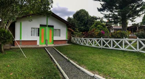 a house with green and red doors in a yard at Room in Guest room - Room with 2 double beds number 14 in Rizaralda