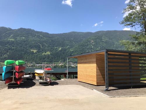 a shed and a motorcycle parked next to a building at Feriendorf Berghof in Villach