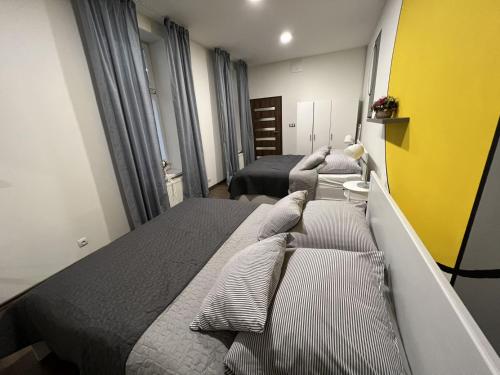 a bedroom with two beds and a yellow wall at FLEXIHOME sk - Design City - top Location close city centre - big squared in Košice