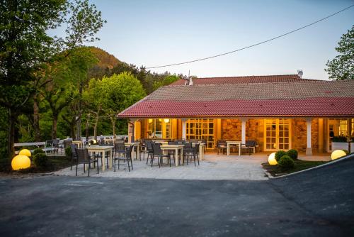 a restaurant with tables and chairs in front of a building at IXUA Hotela in Éibar