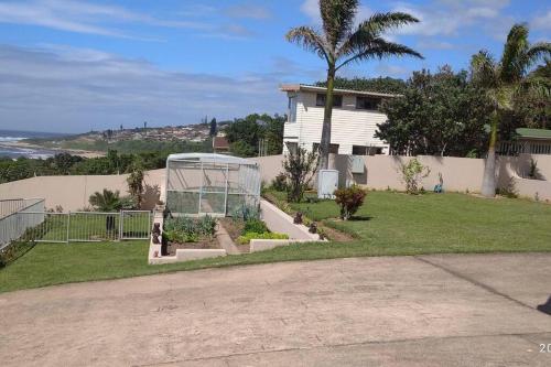 a house with a garden in front of a house at Three on Freefall in Elysium