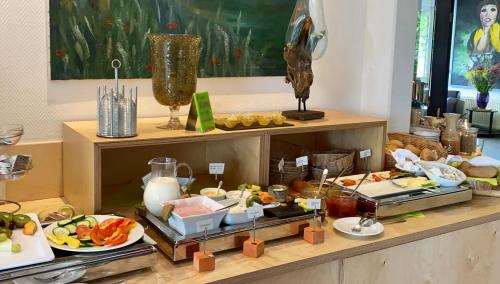 a buffet with a lot of food on a table at Hotel am Müritz-Nationalpark in Waren