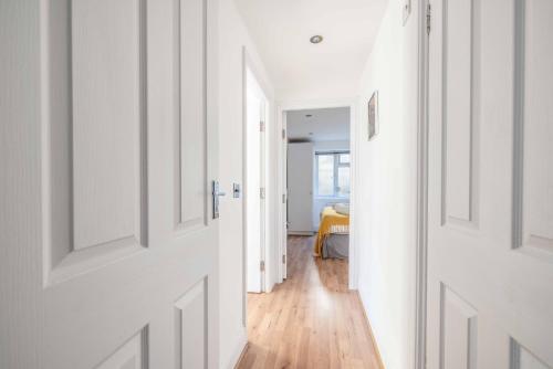 a hallway with white doors and a bedroom at Windsor centre Parkview in Windsor