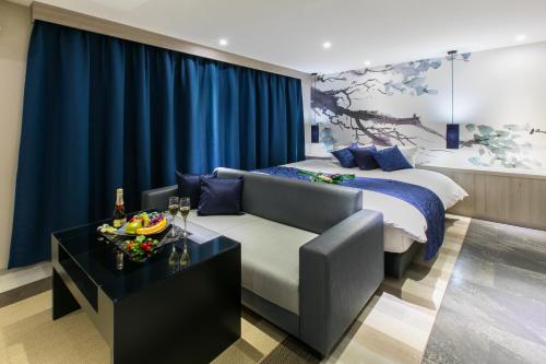 a hotel room with a bed and a couch at HOTEL 粋 in Fukuyama