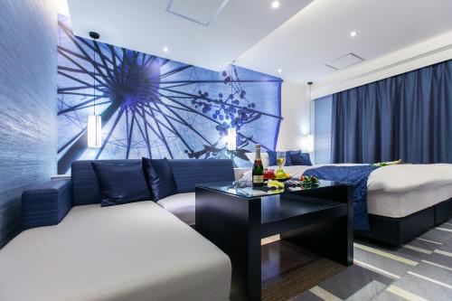 a living room with a couch and a table at HOTEL 粋 in Fukuyama