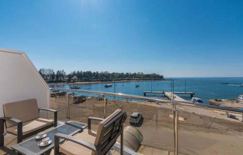 a balcony with chairs and a view of a marina at Rooms Porto 2. floor in Savudrija