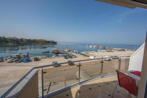 a balcony with a view of a body of water at Rooms Porto 2. floor in Savudrija