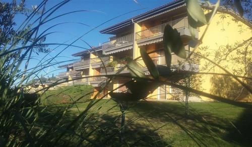 a house on a hill with grass in front of it at Andreis Apartments in Malcesine