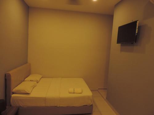 a small bedroom with a bed and a flat screen tv at Golden Leaf Hotel Danga Bay 5 minutes Hospital Hsa,Zoo,Angsana Mall,20 minutes Utm, Legoland in Johor Bahru