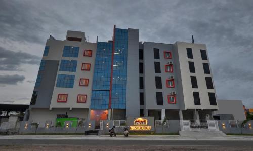 a large building with a sign in front of it at Treebo Trend Everest Residency Tidel Park in Coimbatore