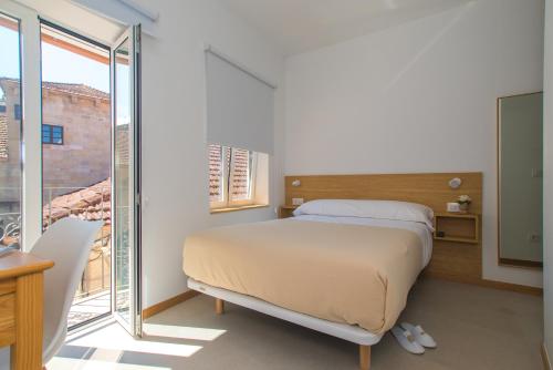 Кровать или кровати в номере Rua do Medio