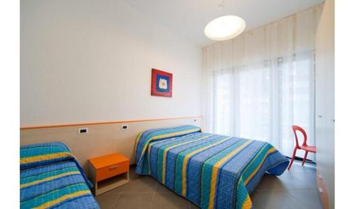 A bed or beds in a room at Condominio Quadrangolo-Gemini