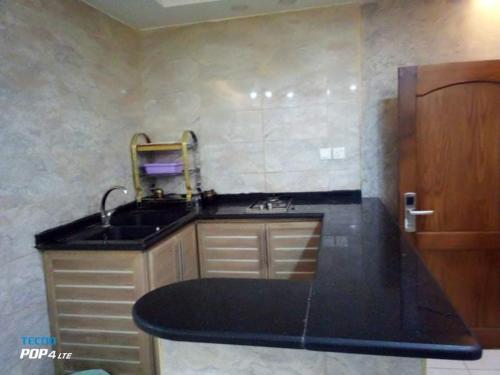 a kitchen with a sink and a counter top at Aqaba Roza in Aqaba