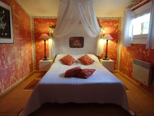 - une chambre avec un lit blanc et 2 oreillers rouges dans l'établissement Locaspera, à Spéracèdes