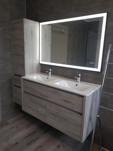 a bathroom with a sink and a mirror at Mary's Poppies - Bed & Breakfast in Blandain