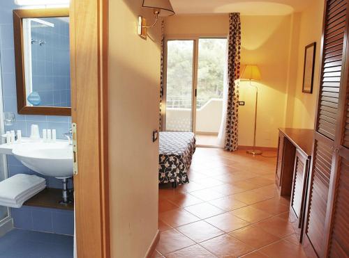 a bathroom with a sink and a toilet at TH Marina di Pisticci - Ti Blu Village in Marina di Pisticci