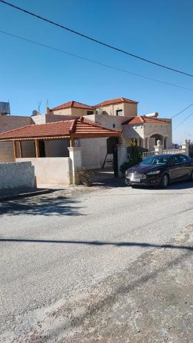 a car parked in front of a house at Petra Stones Inn in Wadi Musa