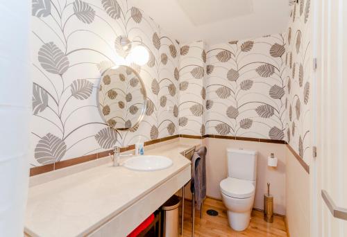 a bathroom with a sink and a toilet at Casas FreshApartments in Málaga
