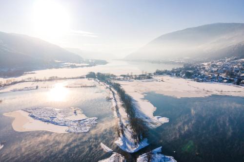 an aerial view of an island in a body of water at Feriendorf Berghof in Villach