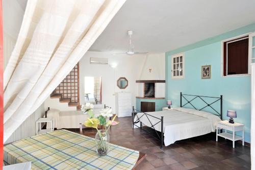 a bedroom with a bed and a table with flowers at La Capasa B&B in Sannicola