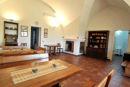 a living room with a table and a fireplace at La Capasa B&B in Sannicola