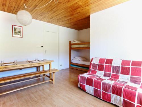 a living room with a couch and a table at Studio Chamrousse, 1 pièce, 4 personnes - FR-1-340-47 in Chamrousse