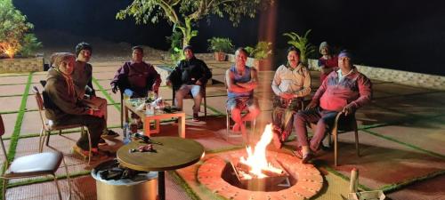 a group of people sitting around a fire pit at Hilltop Resort and Glamping Wai, Near Panchgani in Wai