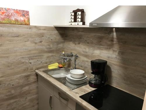 a kitchen counter with a sink and a coffee maker at Ferienwohnung Watzmannblick & Hallenbad in Berchtesgaden