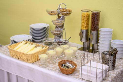 a table with plates and glasses and food on it at Hotel Julianin dvor in Habovka