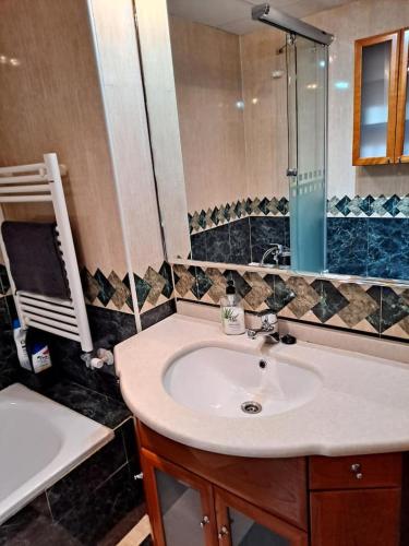 a bathroom with a sink and a mirror at 4AgostoPlace in Zaragoza