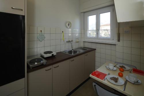 a small kitchen with a sink and a counter at Apartment Casa Thuja in Ascona