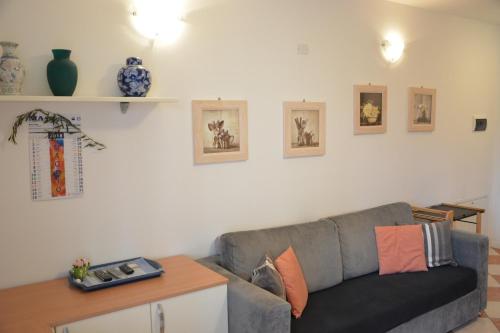 a living room with a gray couch and a table at Grand Hotel Liberty in Riva del Garda