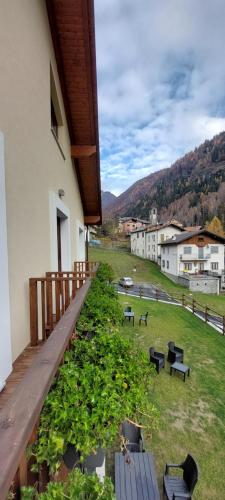 a balcony of a building with tables and benches at Locanda della Luna in Ronco Canavese