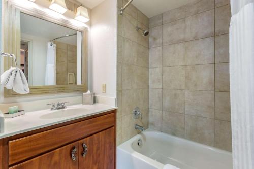 a bathroom with a sink and a tub and a mirror at Bluegreen Vacations Club 36 in Las Vegas