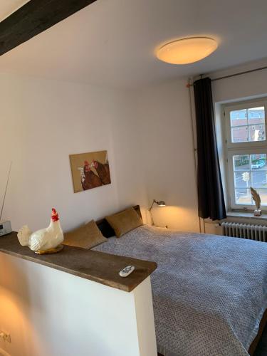 a bedroom with a bed and a window at trash de luxe in Schleswig