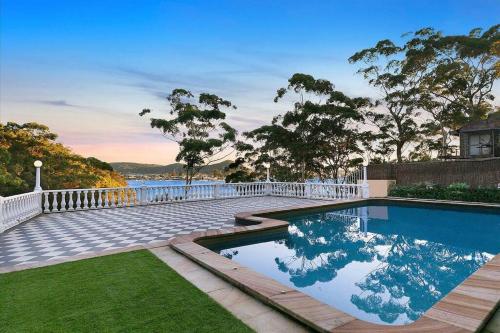 a swimming pool with a white fence around it at Beautiful Resort Style Living in Lascala 126 in Booker Bay