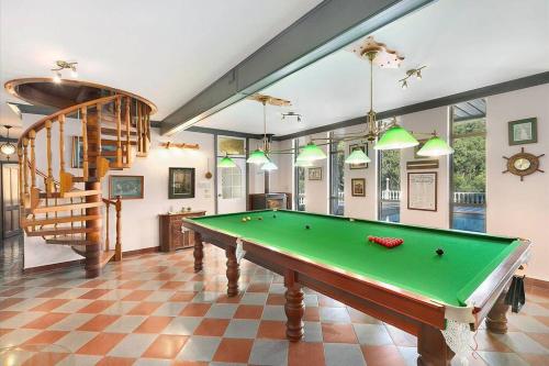 a living room with a pool table and a staircase at Beautiful Resort Style Living in Lascala 126 in Booker Bay