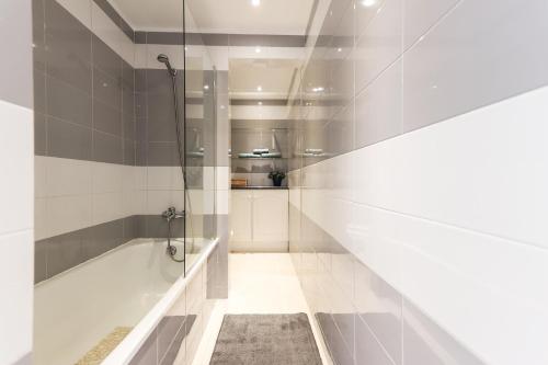 a bathroom with a shower and a bath tub at Lisbon Flower 360º - Your Lovely Flat with Pool and Parking in Lisbon
